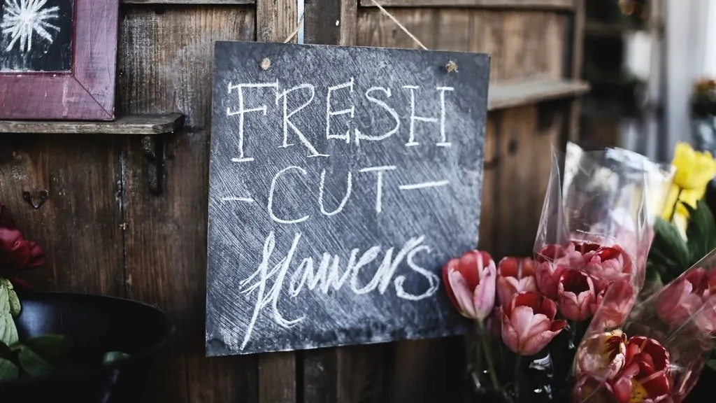 Chalkboard sign outside a small local flower shop