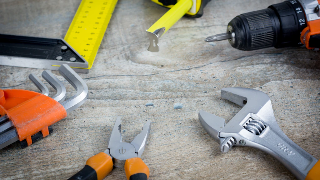 Toolkit with spanner, pliers and drill, representing website maintenance